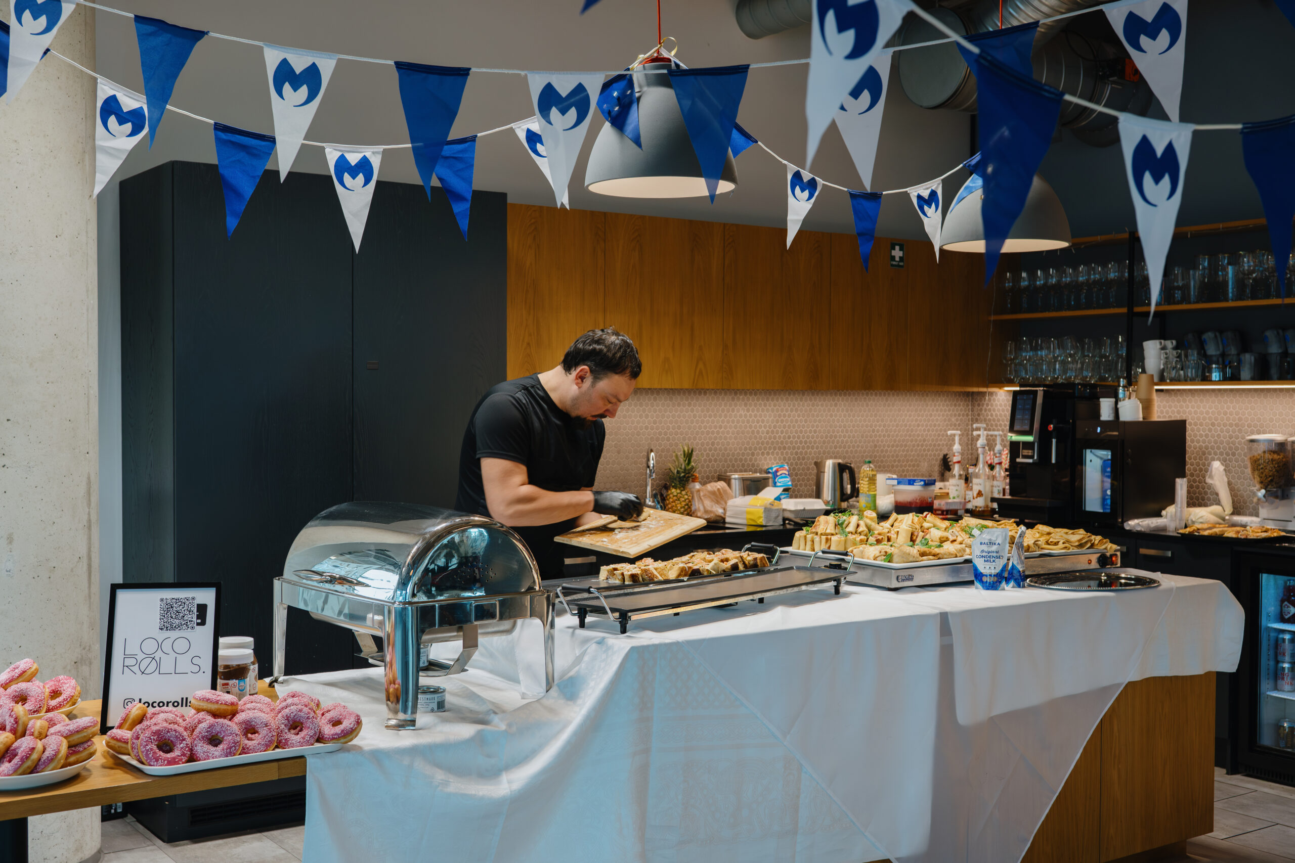 A Loco Rolls chef and a prepared buffet at an event